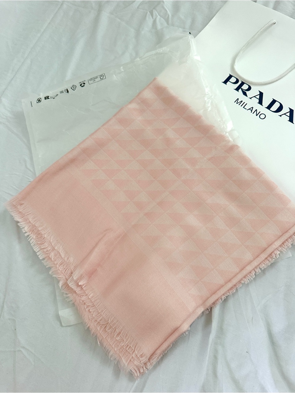 Prada Symbole Silk and Wool Jacquard Shawl in a light pink color.